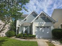 Charming two-story home featuring well-maintained landscaping, inviting curb appeal, and a convenient attached garage at 1715 Crabapple Tree Ln, Charlotte, NC 28214