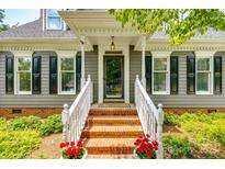 Charming home featuring a brick entrance with well-maintained landscaping and a welcoming front porch at 1887 Steeplechase Dr, Rock Hill, SC 29732
