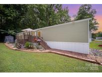 Charming single story home featuring a quaint front porch, manicured lawn and mature trees at 251 Birch Tree Rd, Clover, SC 29710