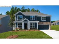 Charming two-story home featuring a blue exterior, complemented by a well-manicured lawn at 265 Miramar Dr, York, SC 29745