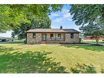 Charming stone and siding home with well-maintained lawn and inviting front porch at 3372 Lee Lawing Rd, Lincolnton, NC 28092