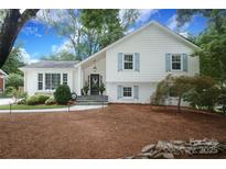 Charming two-story home with blue shutters, landscaped yard, brick accents, and inviting front porch at 4126 Tyndale Ave, Charlotte, NC 28210