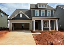 New two-story home with a spacious two-car garage and classic architectural details at 626 Amberjack Pl # 79, York, SC 29745