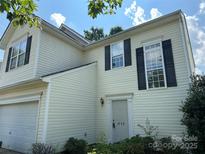 Charming home featuring a two-story design, light siding, and black shutters, creating a welcoming curb appeal at 8125 Weeping Fig Ln, Charlotte, NC 28215