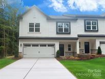 Charming townhome with a two-car garage, modern farmhouse touches, and well manicured lawn at 8303 Adrian Ct, Charlotte, NC 28270