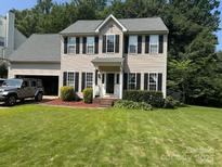 Traditional two-story home featuring a well-manicured lawn and an attached two car garage at 108 Shade Tree Cir, Fort Mill, SC 29715