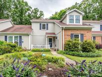 Charming townhome featuring a well-maintained yard, beautiful landscaping and blue shutters at 11120 Sevilla Ct, Charlotte, NC 28226