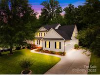 Beautiful two-story home with a manicured lawn and long driveway at 136 Pink Orchard Dr, Mooresville, NC 28115