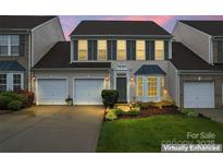 Charming two-story home featuring a two-car garage, well-manicured lawn, and beautiful landscaping at 1418 Skidaway Nw St # 427, Concord, NC 28027