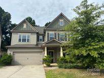 Charming two-story home with a two-car garage and well-maintained landscaping at 145 W Morehouse Ave, Mooresville, NC 28117