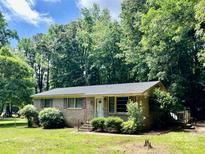 Charming brick home with a well-maintained front yard and mature trees under a blue sky at 2201 Airdale Rd, Lancaster, SC 29720
