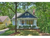 Charming two-story home with a manicured lawn and a classic blue and grey exterior paint scheme at 2223 Club Rd, Charlotte, NC 28205