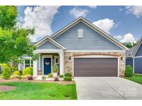 Charming home featuring a two-car garage, well-manicured lawn, and tasteful landscaping for curb appeal at 2261 Lincolnshire Ln, Waxhaw, NC 28173