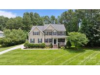 Charming two-story home with manicured lawn, front porch, and lush landscaping at 274 Cove Creek Loop, Mooresville, NC 28117