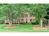 Charming brick home with a well-manicured lawn and mature trees, offering great curb appeal at 3112 Planters Ridge Rd, Charlotte, NC 28270