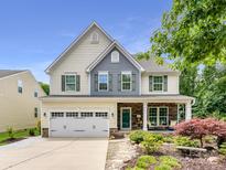 Charming two-story home featuring a stone-accented front porch and a well-manicured, landscaped yard at 3609 Benseval Ln, Matthews, NC 28105
