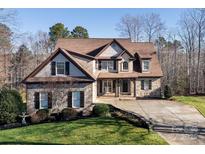Charming two-story home with a combination of stone, wood, and stucco exterior at 394 Stonecliff Ln, Clover, SC 29710