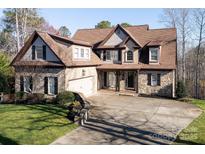 Charming two-story home featuring stone accents, attached garage, and a well-manicured front yard at 394 Stonecliff Ln, Clover, SC 29710