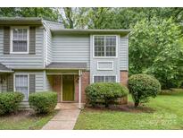 Charming townhome with a well-manicured lawn, brick accents, and a cozy, covered front entry at 3941 Briarhill Dr, Charlotte, NC 28215