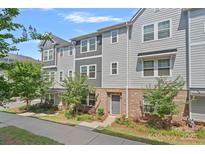 Charming townhouse with a gray exterior, brick accents, and well-maintained landscaping at 4008 Yucca Aly, Charlotte, NC 28217