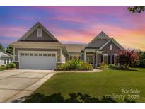 Charming single-story home with well-manicured lawn, flowerbeds, and attached two-car garage at 4208 Rosy Billed Ct # 30, Fort Mill, SC 29707