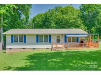 Charming single-story home featuring blue shutters and a welcoming front porch at 426 Valley St, Stanley, NC 28164