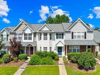 Charming townhome with well-manicured lawn and colorful landscaping, offering inviting curb appeal at 6128 Warrior Ave, Fort Mill, SC 29707