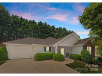 Charming single-story home with a one-car garage, complemented by manicured landscaping and a welcoming entrance at 110 Whitehall Dr, Mooresville, NC 28117