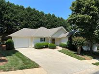 Charming single-story home featuring a well-manicured lawn and an attached garage at 110 Whitehall Dr, Mooresville, NC 28117