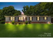 Charming single-story home with well-maintained lawn and inviting front porch at 125 Brasington Ln, Mooresville, NC 28115