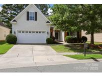Charming home with a two-car garage, mature trees and well-maintained lawn at 13247 Eastfield Village Ln, Charlotte, NC 28269