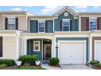 Charming townhouse with blue siding, a one-car garage, and a cozy front porch entrance at 237 River Clay Rd, Fort Mill, SC 29708