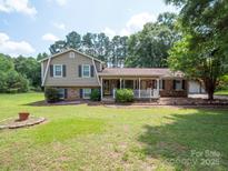 Charming two-story home featuring a welcoming front porch and beautifully landscaped front yard at 409 Ridge Rd, Clover, SC 29710