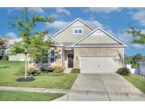 Charming single-Gathering home featuring stone accents, manicured lawn, and a two-car garage at 4333 Legacy Dr, Denver, NC 28037