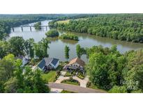 Stunning aerial view of waterfront homes with manicured lawns and beautiful landscaping overlooking the Catawba River at 5888 Wood Duck Way, Catawba, NC 28609