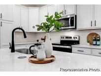 Modern kitchen with stainless steel appliances, white cabinets, and a stylish black faucet at 10339 Lakeshore Dr # 85, Lancaster, SC 29720
