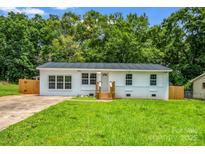 Charming, updated one-story home featuring a metal roof, fresh white paint and beautiful landscaping at 111 Wolfe Rd, Shelby, NC 28152