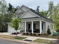Charming home with a covered porch featuring columns and inviting outdoor seating, perfect for relaxing at 11404 James Coy Rd, Davidson, NC 28036