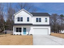 Charming two-story home with a bright blue door and well-manicured lawn at 118 Durham Rd, Stanley, NC 28164