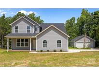 Charming two-story home with gray siding and a well-maintained yard at 126 Aurora Blvd, Matthews, NC 28105