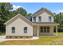 Charming new construction home features a welcoming front porch and a well-manicured lawn at 130 Aurora Blvd, Matthews, NC 28105