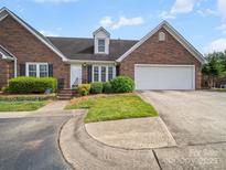 Charming brick home with a two-car garage, landscaped yard, and inviting entryway in a desirable neighborhood at 1634 - B Union Rd, Gastonia, NC 28054