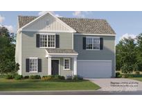 Charming two-story home with sage siding, black shutters, and a two-car garage offers a welcoming curb appeal at 1904 Old Ormand Ln, Bessemer City, NC 28016