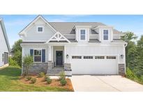 Charming two-story home featuring light blue siding, stone accents, and a welcoming front porch at 24578 Blue Heron Cir # 407, Lancaster, SC 29720