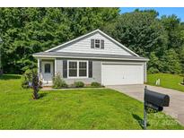 Charming one-story home featuring a well-manicured lawn and an attached garage, perfect for suburban living at 611 Annalinde Ln, Rock Hill, SC 29732