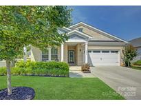 Charming brick home with a well-maintained front yard, lush landscaping, and attached two-car garage at 9226 Dunwich Dr, Gastonia, NC 28056
