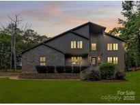 Stunning two-story home featuring a stone facade, well-maintained lawn, and inviting entryway at 9423 Man O War Rd, Fort Mill, SC 29707