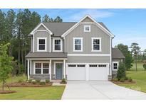 Charming two-story home with gray siding, white trim, a well-manicured lawn, and an attached two-car garage at 9858 Jack Nicklaus Dr # 897, Lancaster, SC 29720