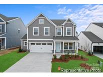 Two-story home featuring a gray facade, manicured lawn, and a two-car garage at 9858 Jack Nicklaus Dr # 897, Lancaster, SC 29720