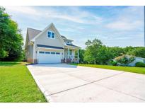 Charming home with a long concrete driveway, attached garage, and well-manicured front lawn at 102 Starmount Dr, Kings Mountain, NC 28086